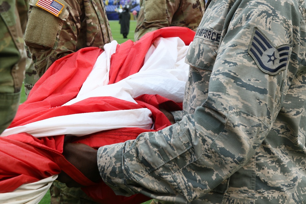 Maryland National Guard Soldiers and Airmen display flag at Baltimore Ravens Game