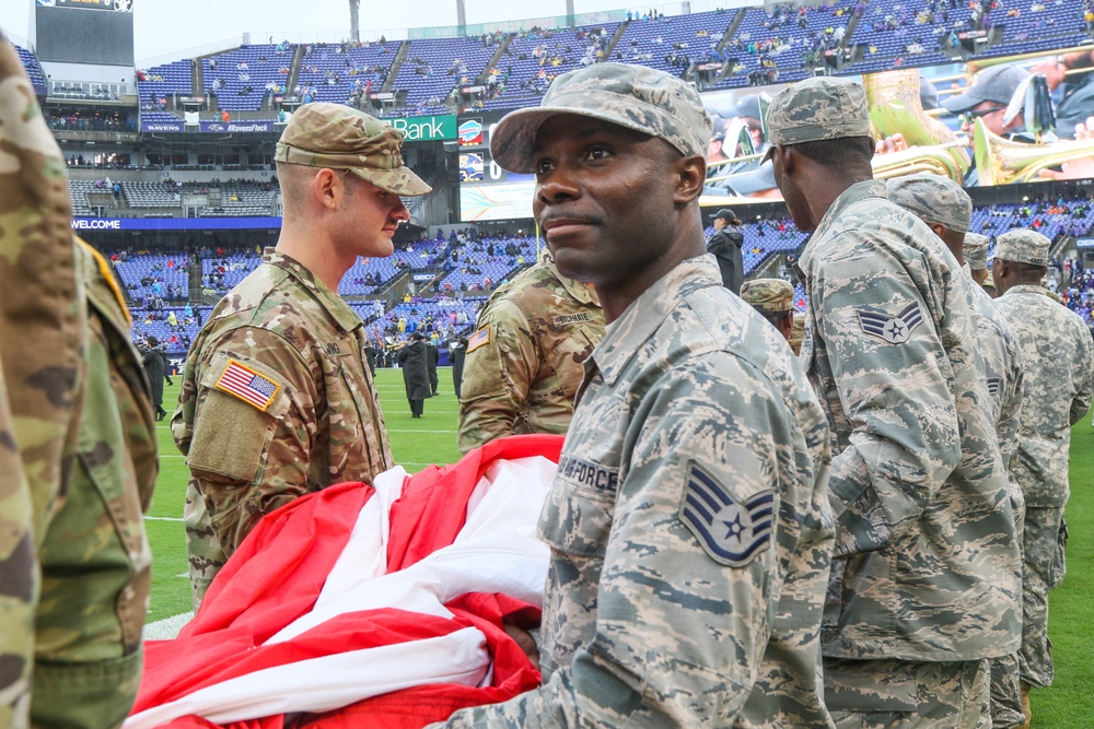 Maryland National Guard Soldiers and Airmen display flag at Baltimore Ravens Game