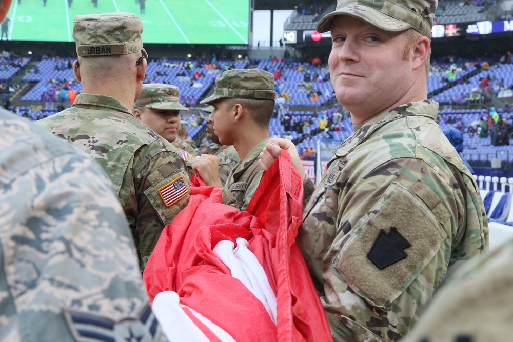 Maryland National Guard Soldiers and Airmen display flag at Baltimore Ravens Game