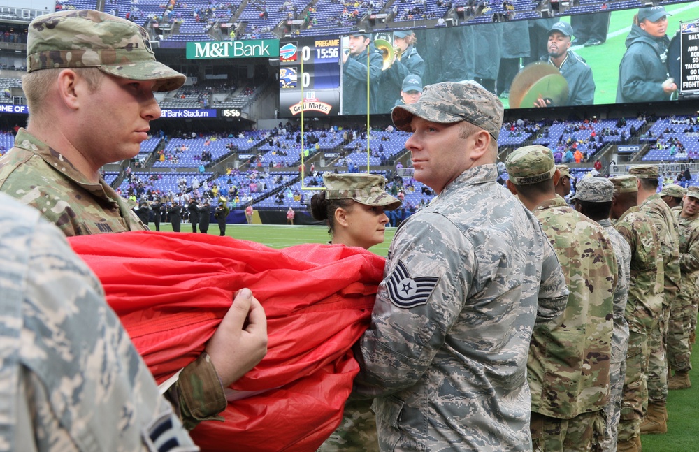 Maryland National Guard Soldiers and Airmen display flag at Baltimore Ravens Game