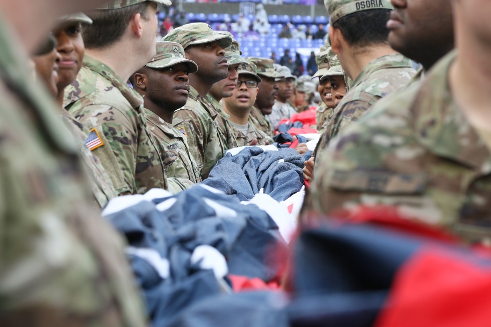 Maryland National Guard Soldiers and Airmen display flag at Baltimore Ravens Game