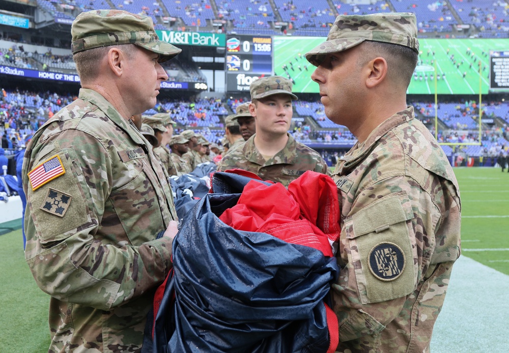 Maryland National Guard Soldiers and Airmen display flag at Baltimore Ravens Game