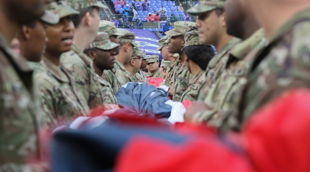 Maryland National Guard Soldiers and Airmen display flag at Baltimore Ravens Game