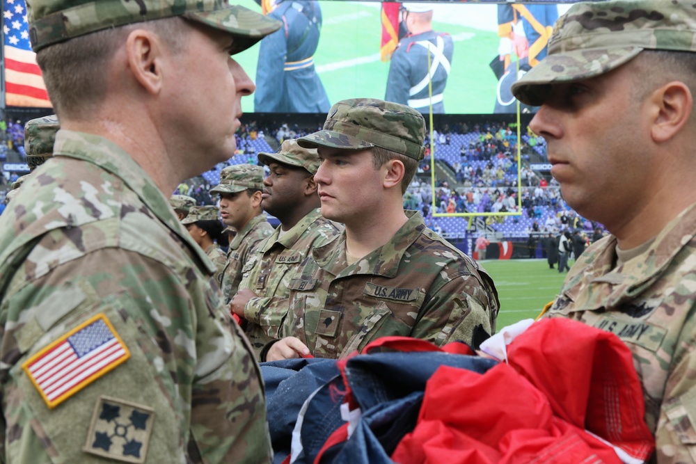 Maryland National Guard Soldiers and Airmen display flag at Baltimore Ravens Game