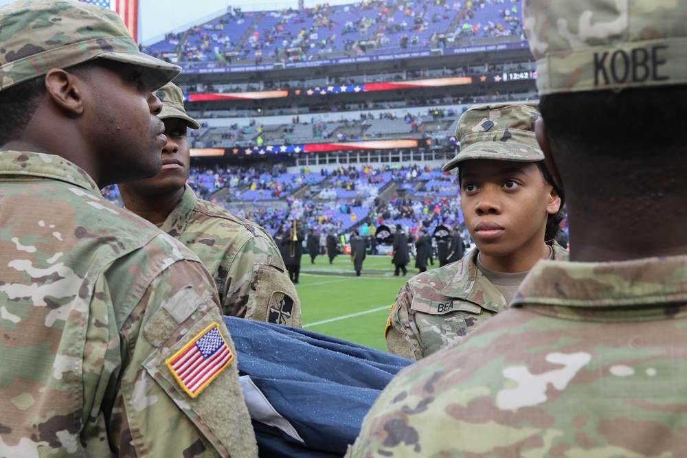 Maryland National Guard Soldiers and Airmen display flag at Baltimore Ravens Game