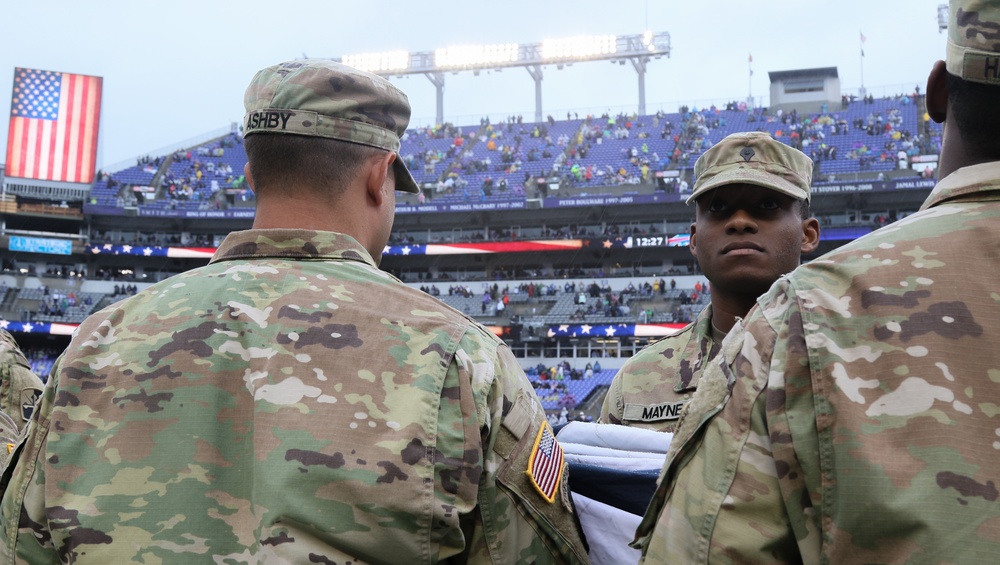 Maryland National Guard Soldiers and Airmen display flag at Baltimore Ravens Game