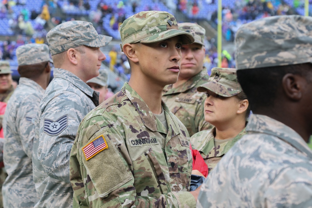 Maryland National Guard Soldiers and Airmen display flag at Baltimore Ravens Game