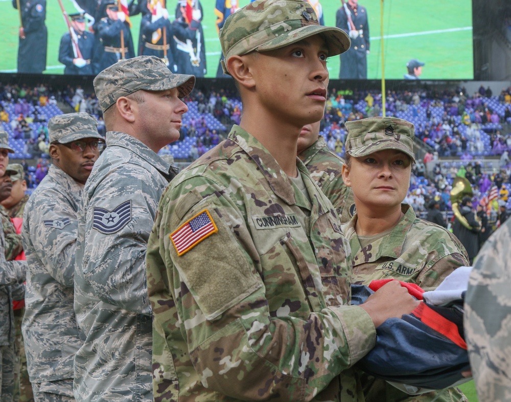 Maryland National Guard Soldiers and Airmen display flag at Baltimore Ravens Game