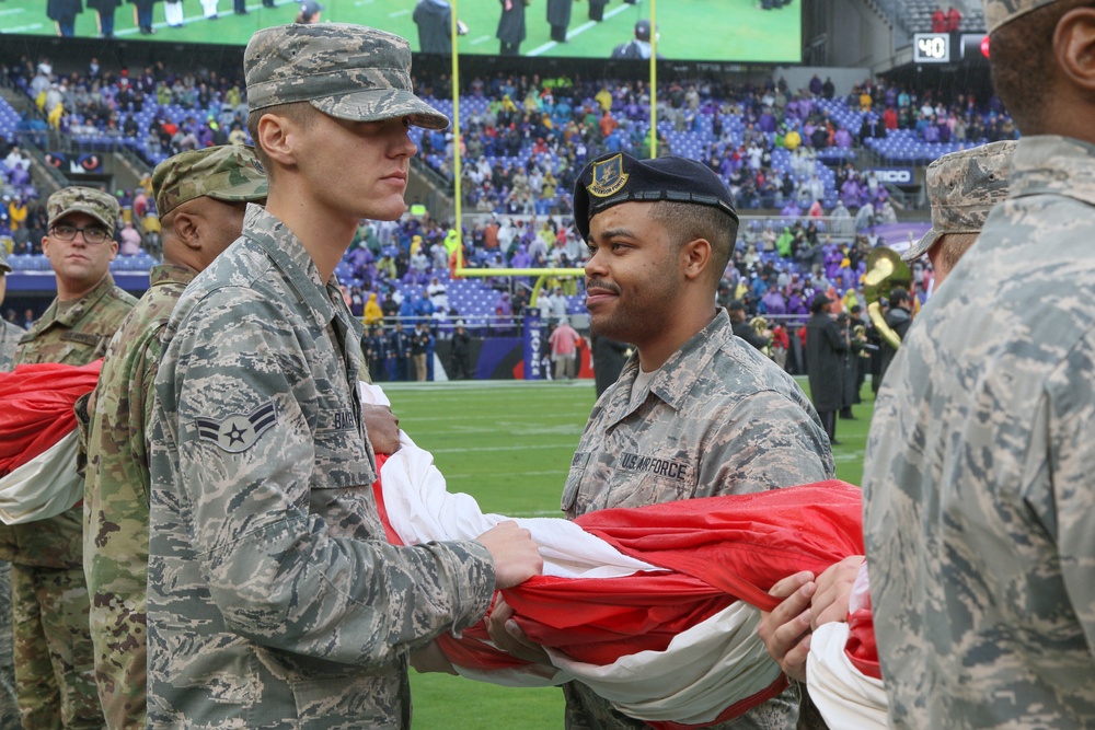 Maryland National Guard Soldiers and Airmen display flag at Baltimore Ravens Game