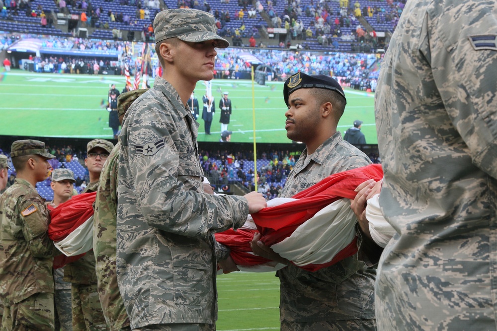 Maryland National Guard Soldiers and Airmen display flag at Baltimore Ravens Game