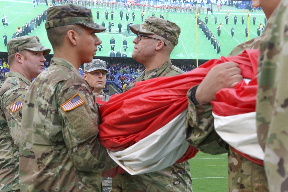 Maryland National Guard Soldiers and Airmen display flag at Baltimore Ravens Game