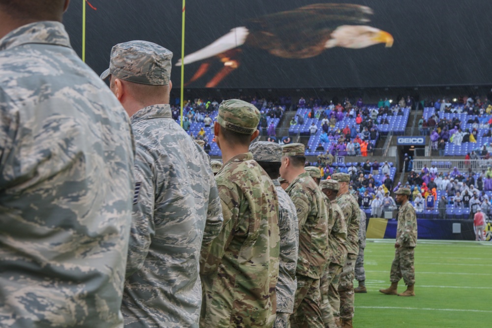 Maryland National Guard Soldiers and Airmen display flag at Baltimore Ravens Game