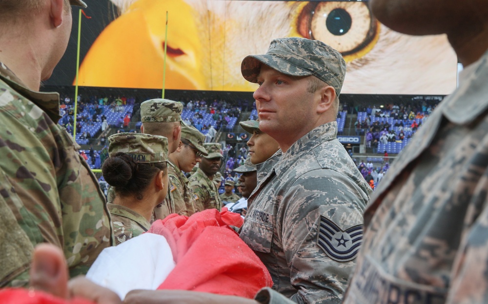 Maryland National Guard Soldiers and Airmen display flag at Baltimore Ravens Game