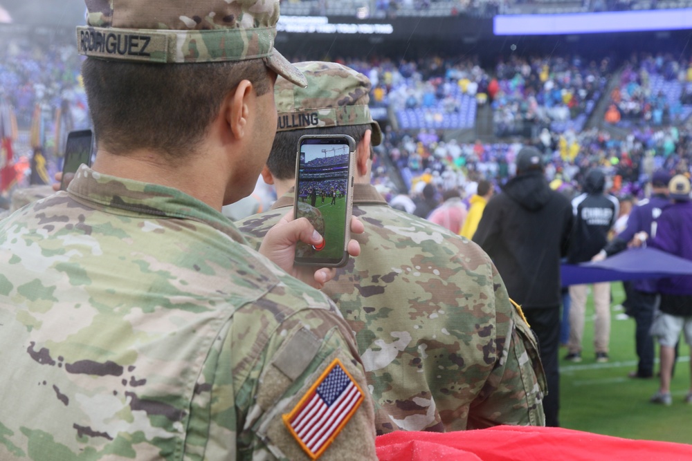 Maryland National Guard Soldiers and Airmen display flag at Baltimore Ravens Game