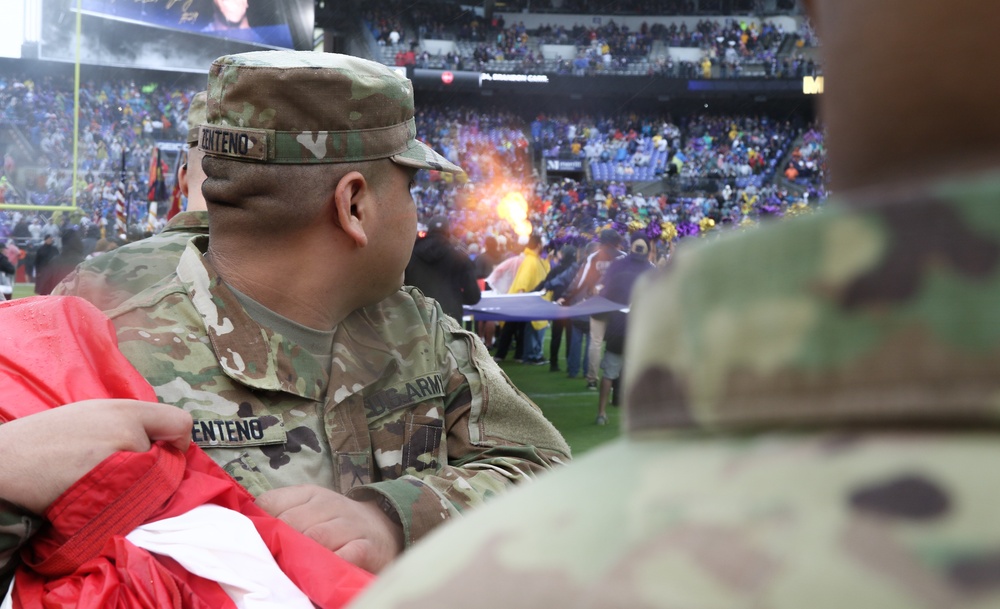 Maryland National Guard Soldiers and Airmen display flag at Baltimore Ravens Game