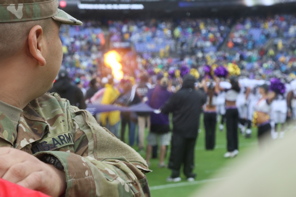 Maryland National Guard Soldiers and Airmen display flag at Baltimore Ravens Game