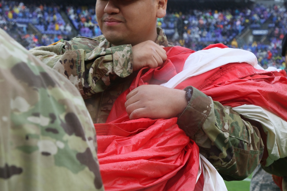 Maryland National Guard Soldiers and Airmen display flag at Baltimore Ravens Game