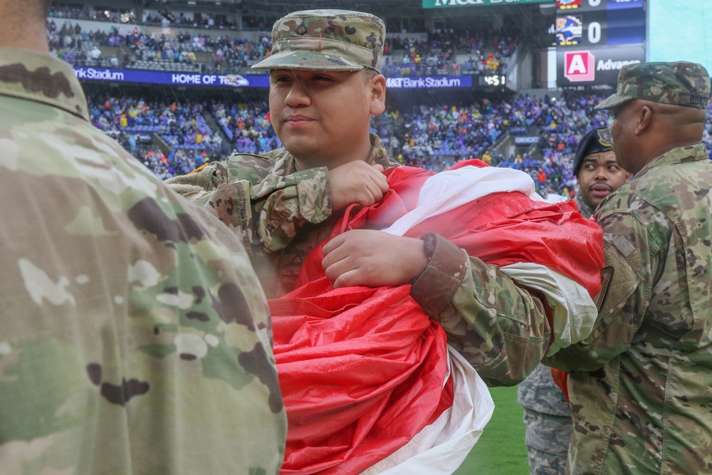 Maryland National Guard Soldiers and Airmen display flag at Baltimore Ravens Game