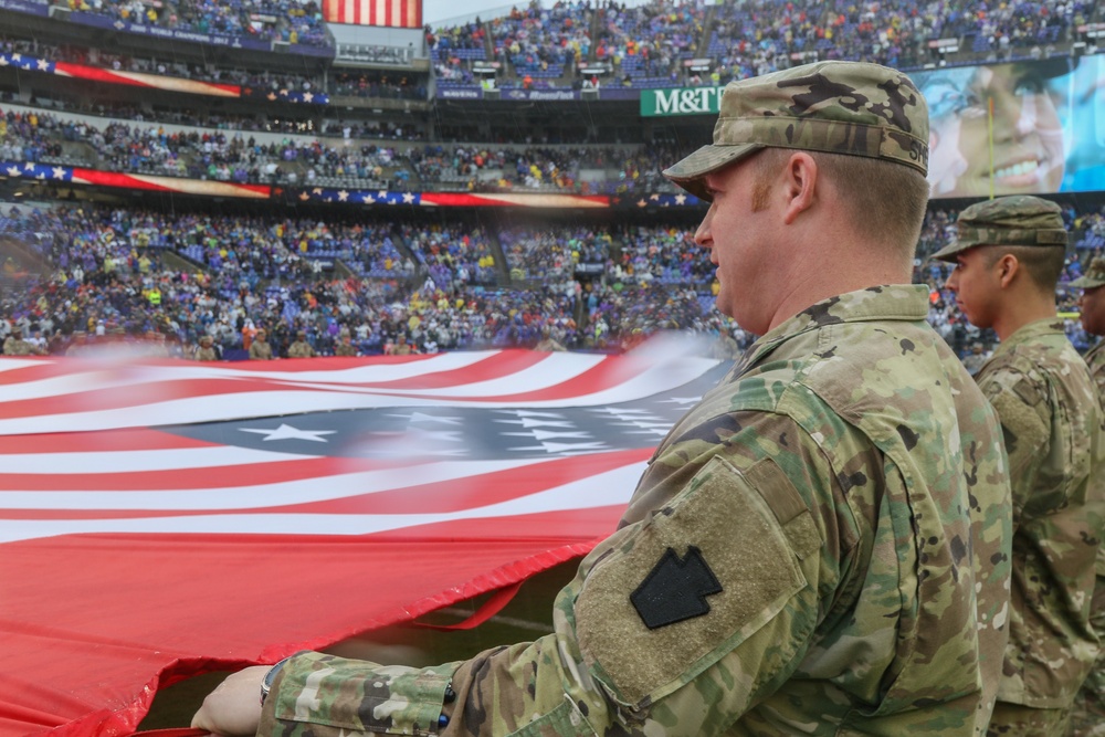 Maryland National Guard Soldiers and Airmen display flag at Baltimore Ravens Game