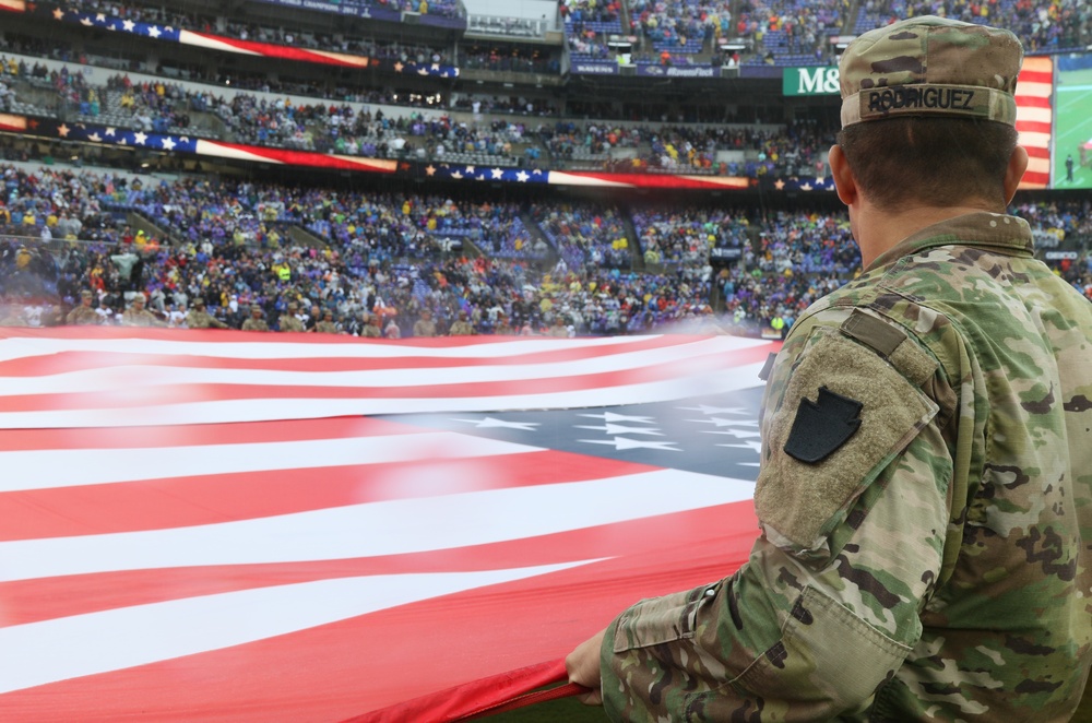 Maryland National Guard Soldiers and Airmen display flag at Baltimore Ravens Game