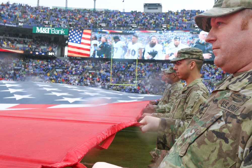 Maryland National Guard Soldiers and Airmen display flag at Baltimore Ravens Game