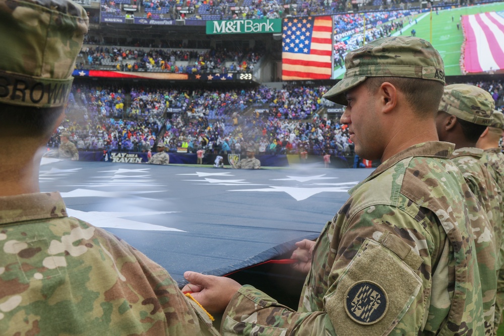 Maryland National Guard Soldiers and Airmen display flag at Baltimore Ravens Game