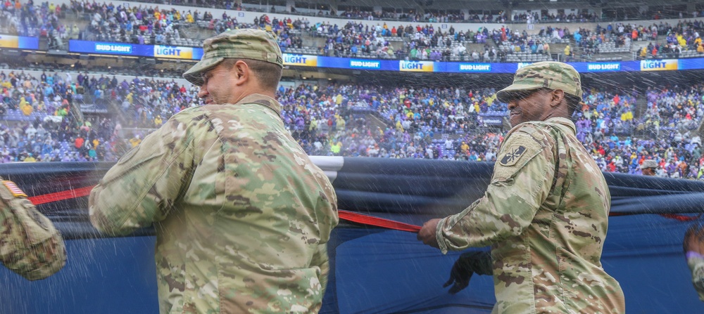 Maryland National Guard Soldiers and Airmen display flag at Baltimore Ravens Game