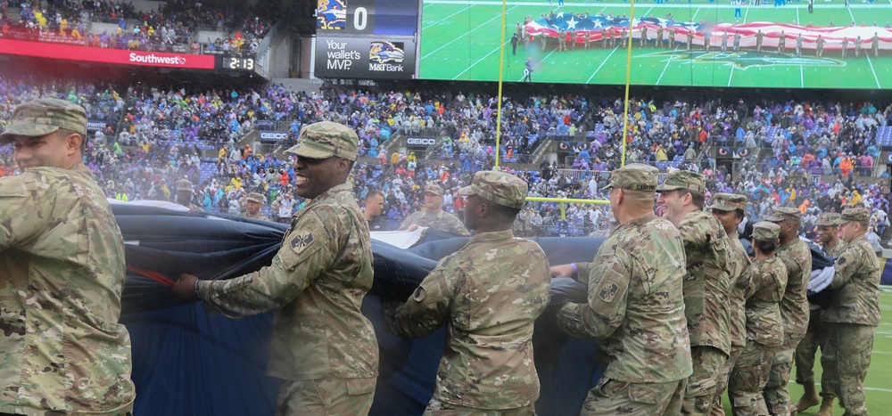 Maryland National Guard Soldiers and Airmen display flag at Baltimore Ravens Game