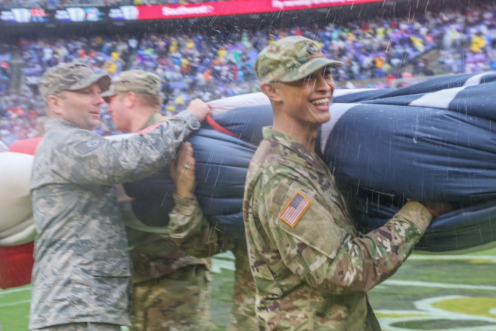 Maryland National Guard Soldiers and Airmen display flag at Baltimore Ravens Game