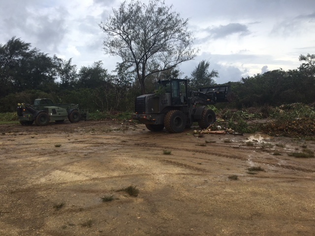 Marines and Navy Seabees clear debris on Tinian