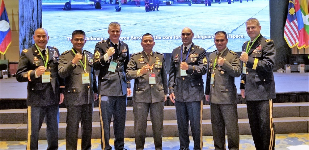 Pacific Armies Management Siminar attendees stand together following panel discussion
