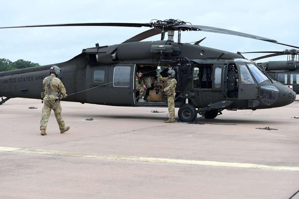 Black Hawk crew inspecting external rescue hoist. 