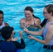 SMP Marines swim with local children during Pool Bash on Camp Kinser