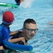 SMP Marines swim with local children during Pool Bash on Camp Kinser