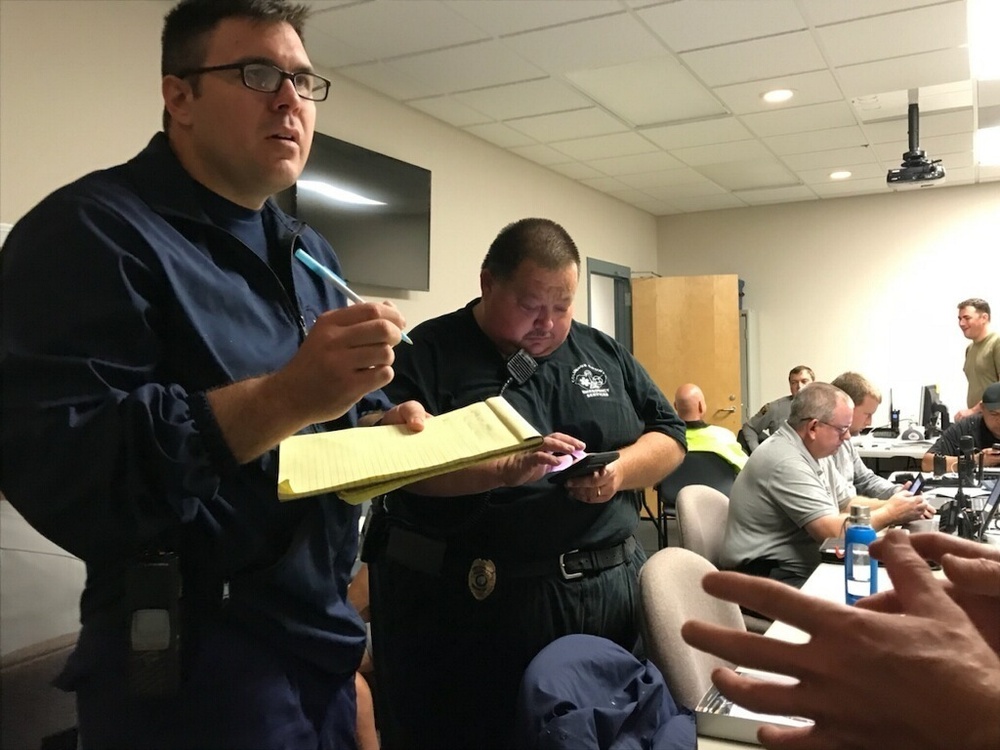 Coast Guard first responders meet with Emergency Operations Center members