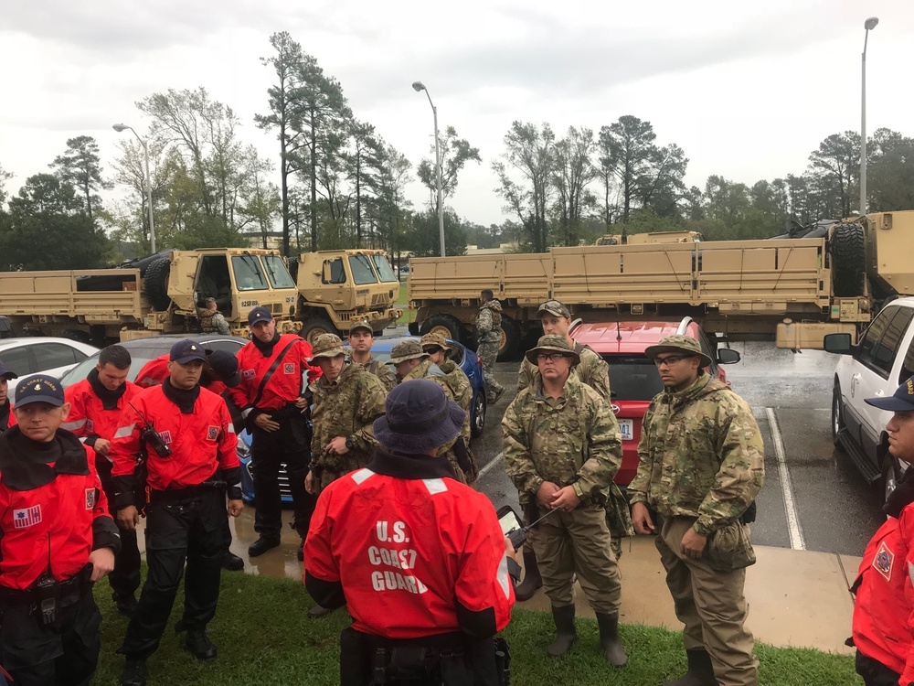 Coast Guard crews discuss tactics prior to conducting rescue operations in response to Hurricane Florence