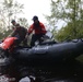 Coast Guard crew lifts team member out of flood water during operations