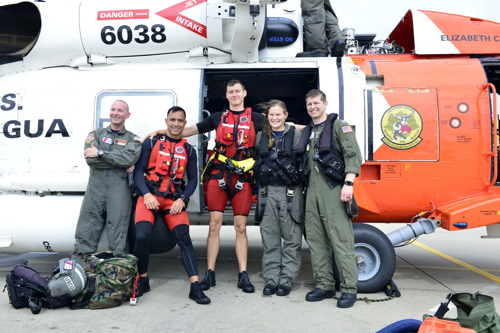 Coast Guard Air Station Elizabeth City helicopter aircrew poses for photo post rescue in NC