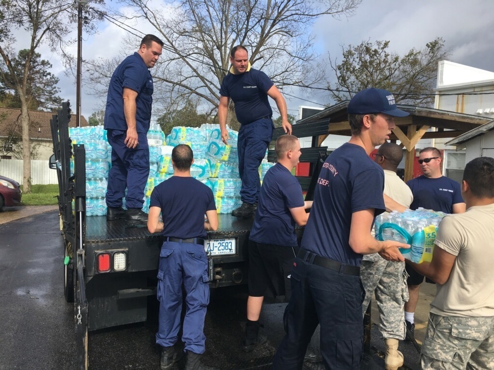 Coast Guard personnel distribute bottled water