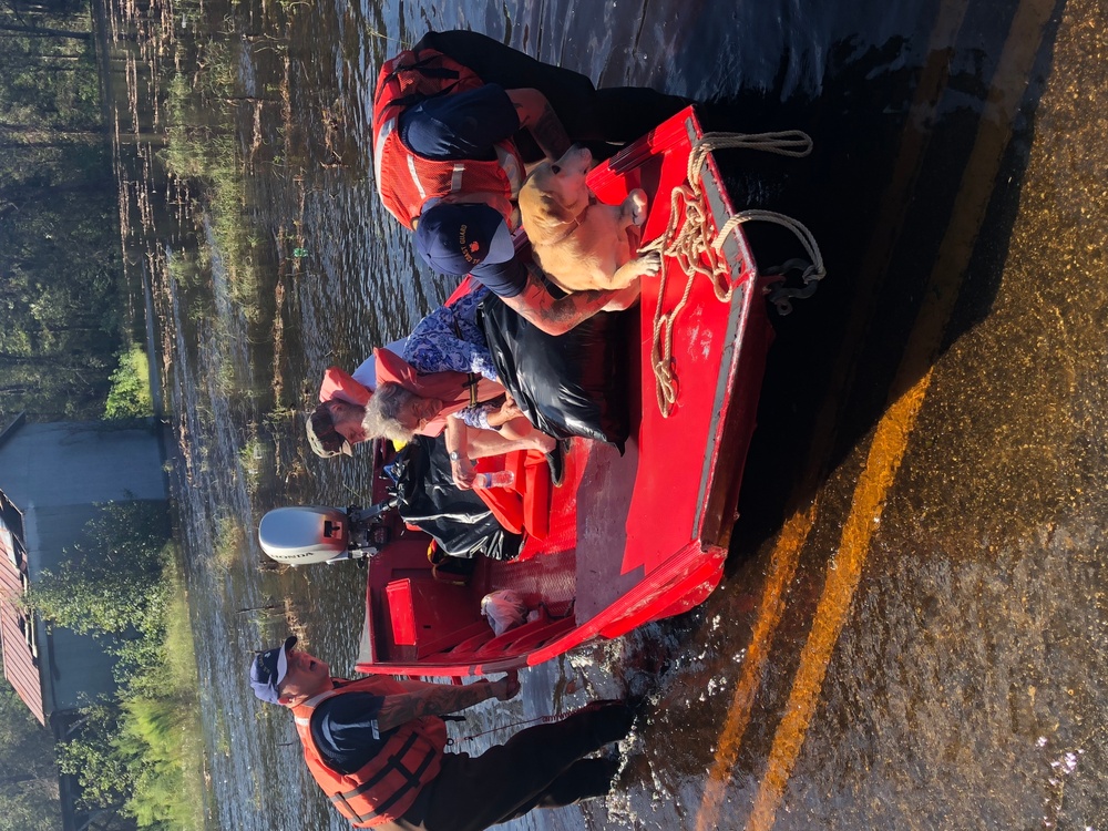 Coast Guard rescues couple and pet dog from flood waters