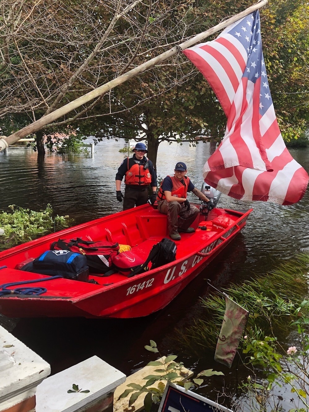 Coast Guard members search for hurricane victims