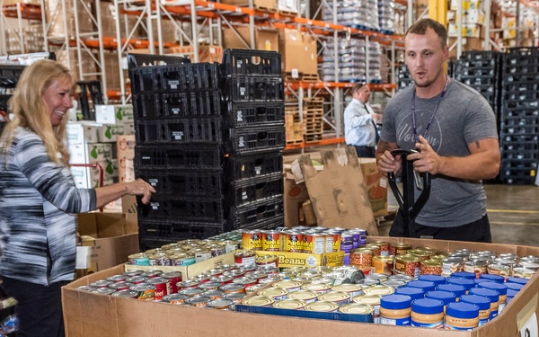 Volunteers unload donations from DLA Land and Maritime at food bank