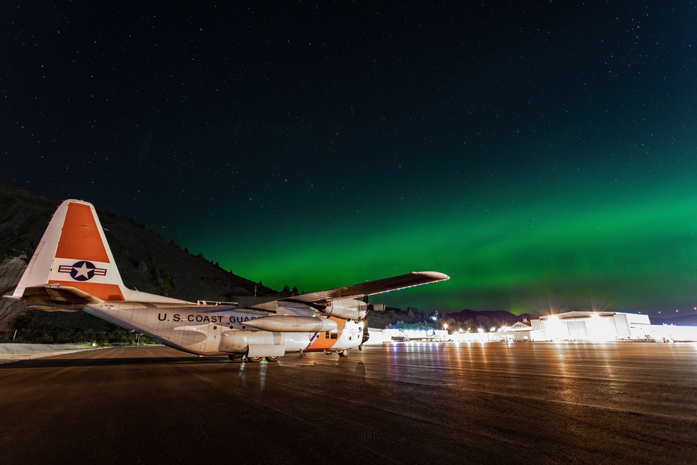 Coast Guard HC-130 rests under northern lights in Kodiak, Alaska