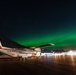 Coast Guard HC-130 rests under northern lights in Kodiak, Alaska