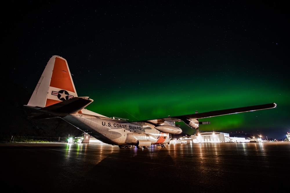 Coast Guard HC-130 rests under northern lights in Kodiak, Alaska
