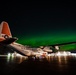 Coast Guard HC-130 rests under northern lights in Kodiak, Alaska