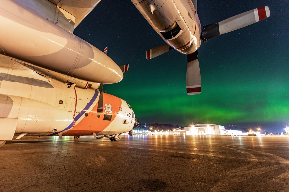 Coast Guard HC-130 rests under northern lights in Kodiak, Alaska