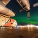 Coast Guard HC-130 rests under northern lights in Kodiak, Alaska