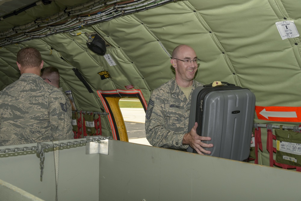 Airmen load aircraft before departing to Ramstein AB