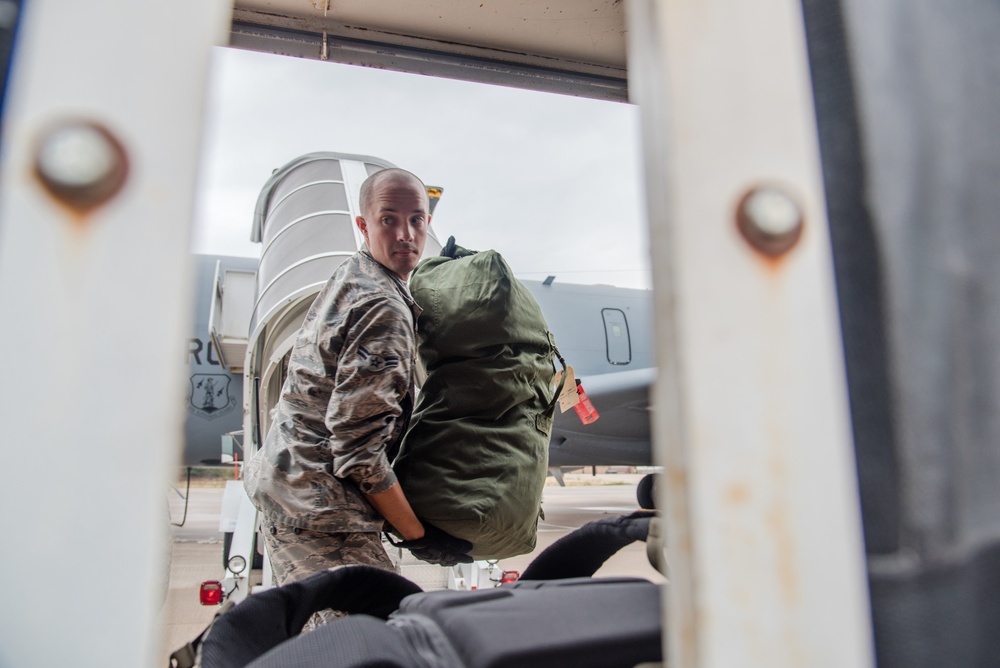 Air Transportation Airmen unloads luggage from a KC-135 Stratotanker
